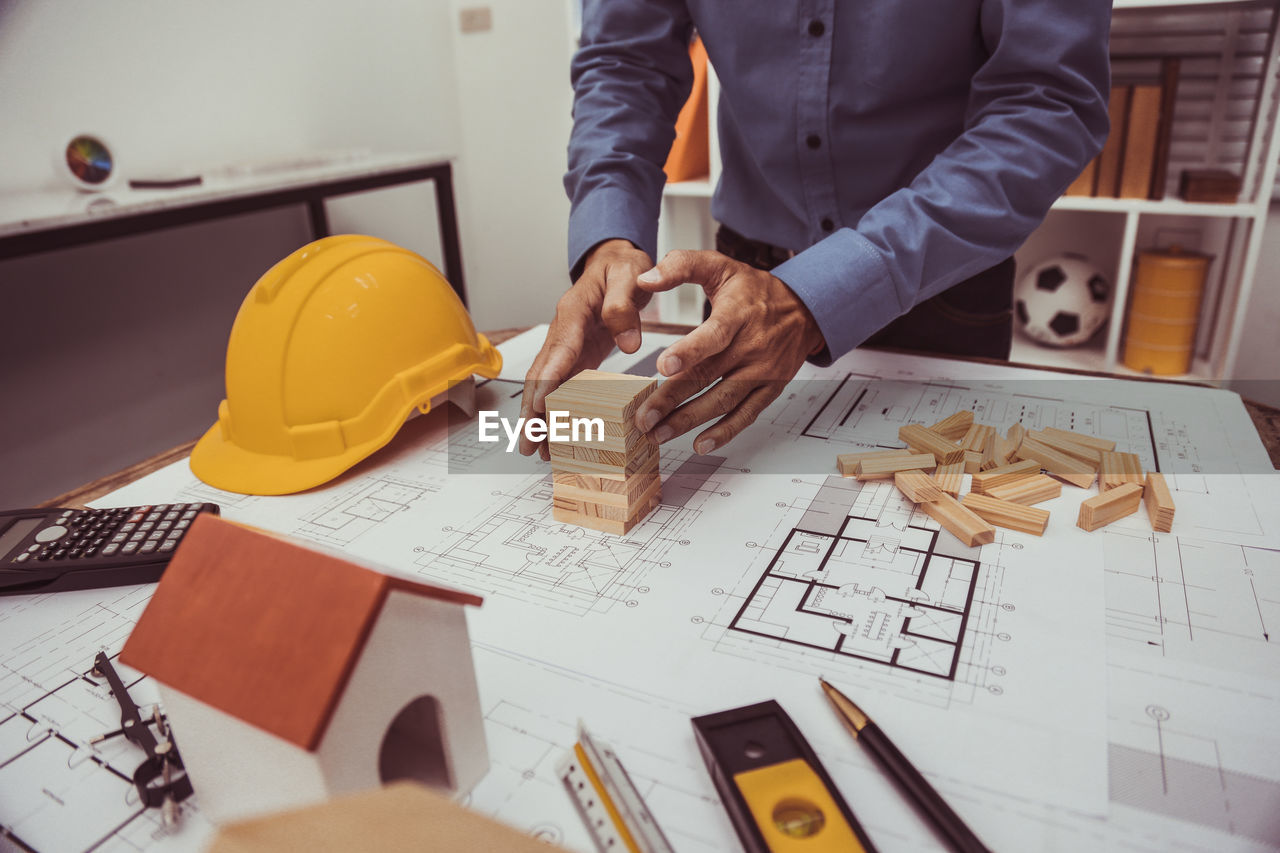 Midsection of man working on table