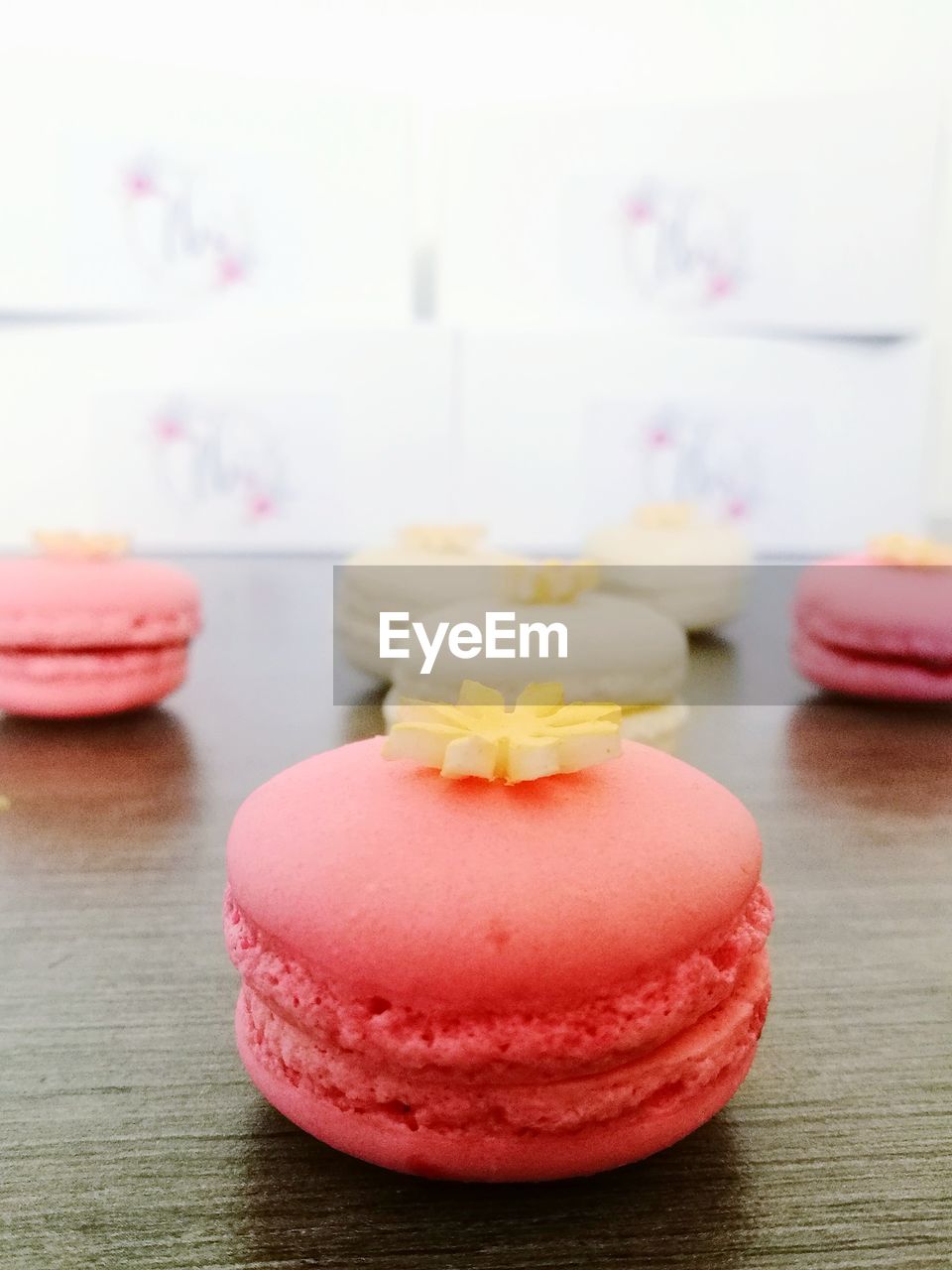 CLOSE-UP OF CAKE WITH PINK ON TABLE