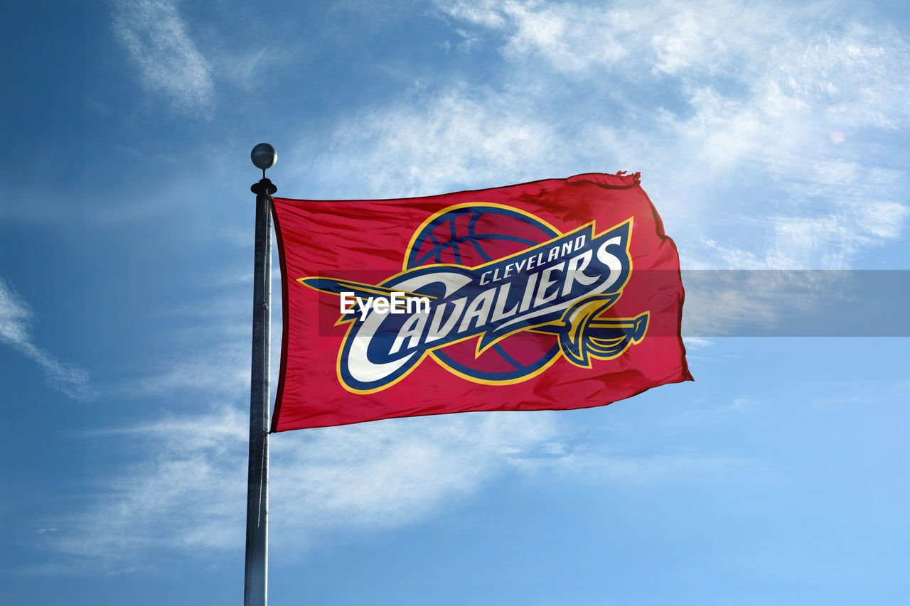LOW ANGLE VIEW OF FLAG SIGN AGAINST SKY