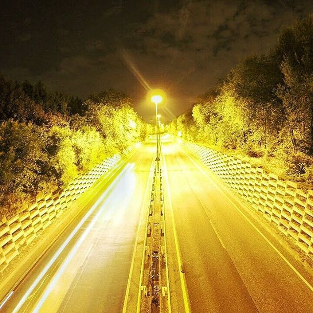 ROAD PASSING THROUGH ILLUMINATED TUNNEL