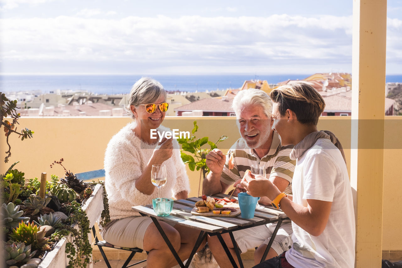 Happy family enjoying food at outdoors restaurant