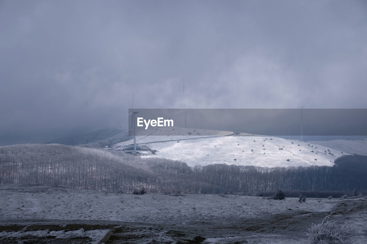 SNOW COVERED MOUNTAINS AGAINST SKY