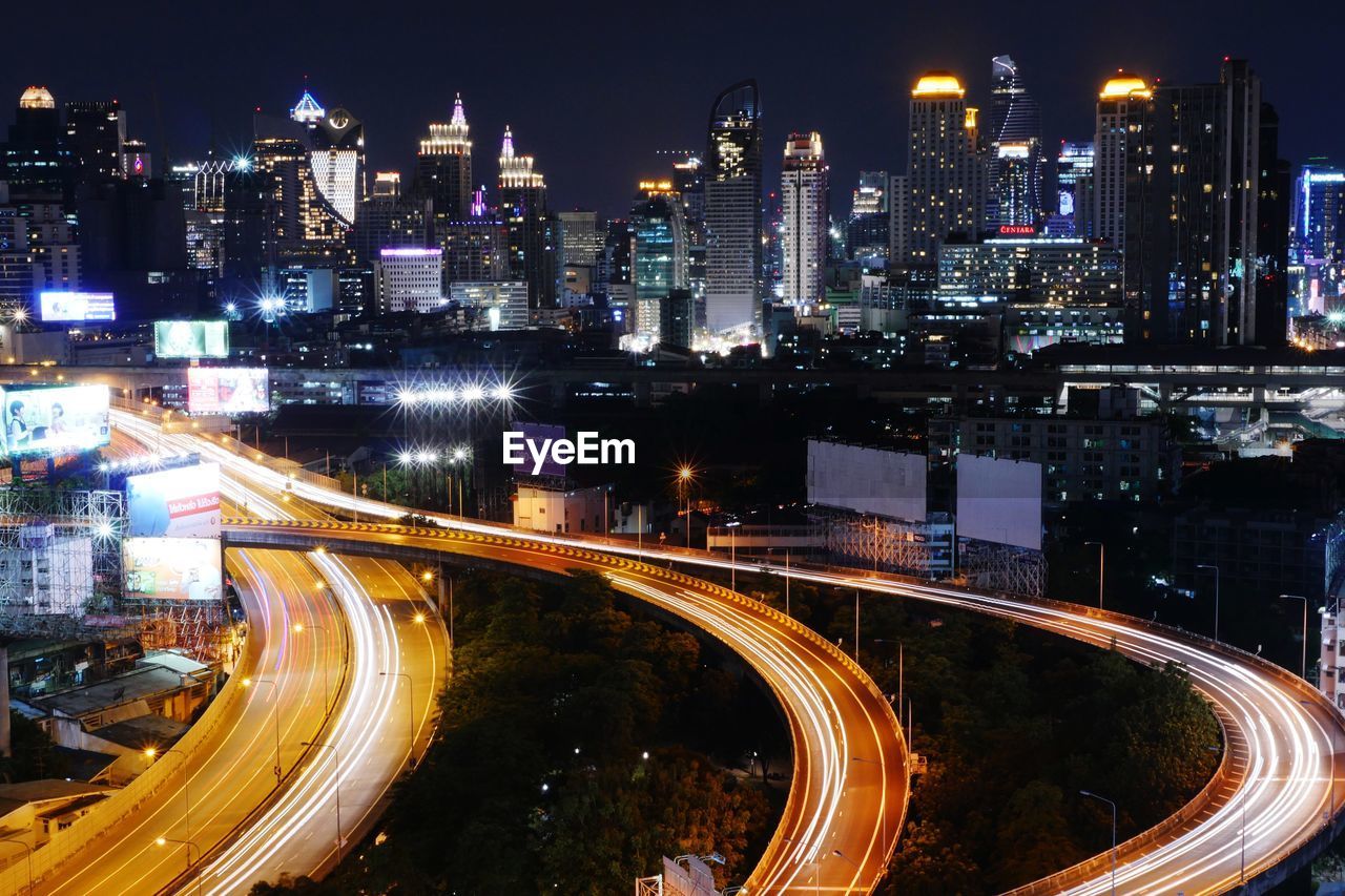 HIGH ANGLE VIEW OF LIGHT TRAILS ON CITY STREET