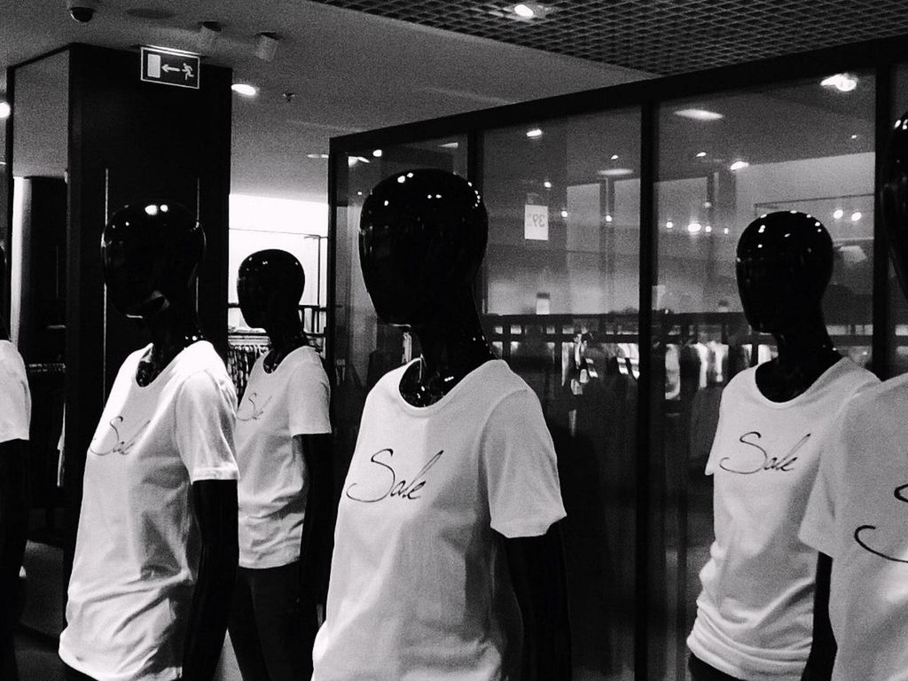 Mannequins displaying white t-shirt in store