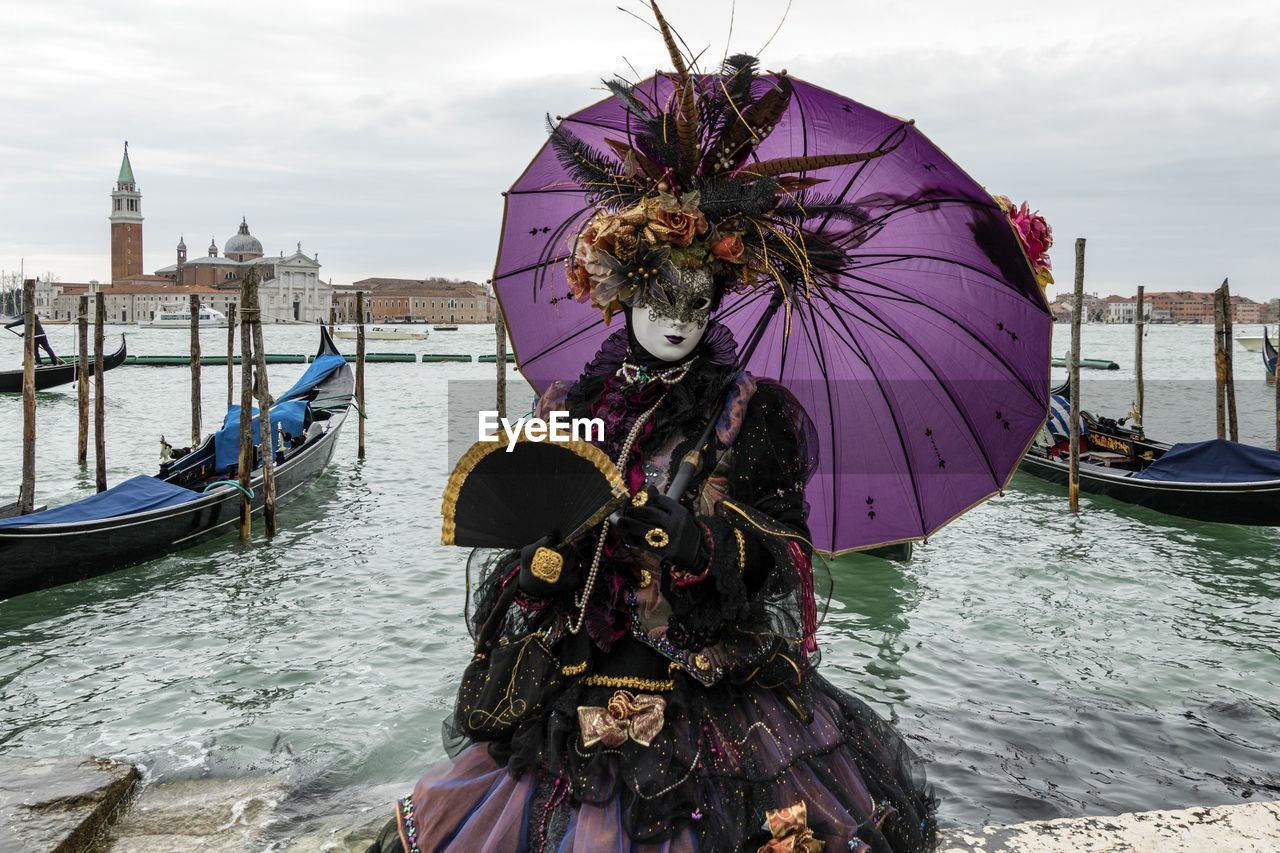 MAN WITH UMBRELLA AGAINST SKY