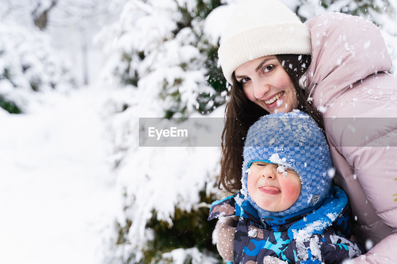 Happy mother and daughter in snow