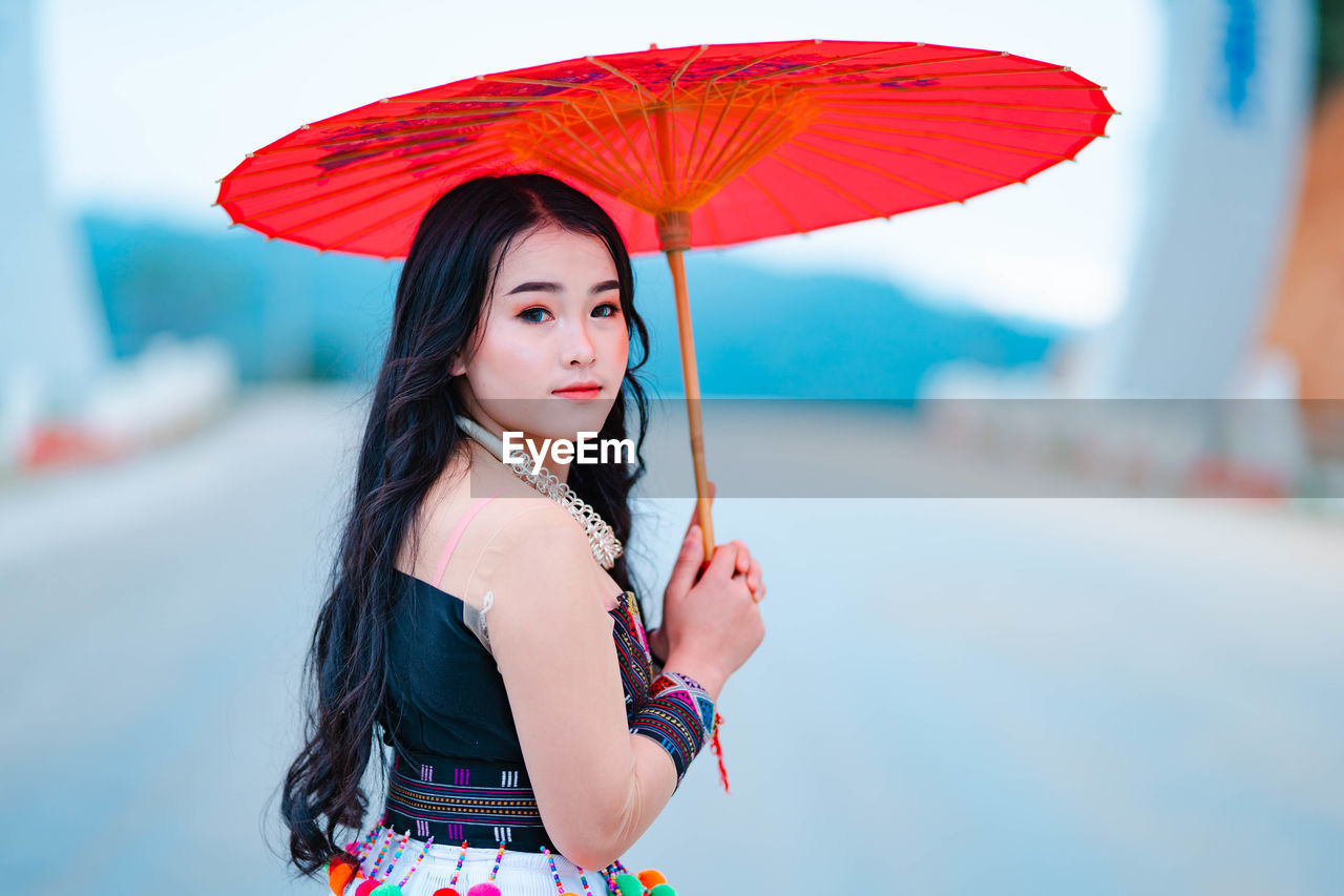 Portrait of young woman standing outdoors