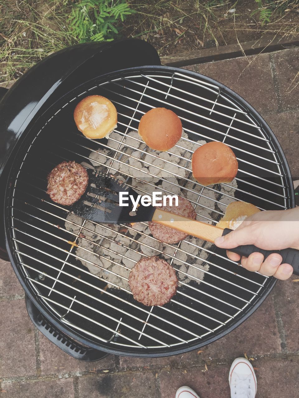 Elevated view of cooking hamburgers on grill