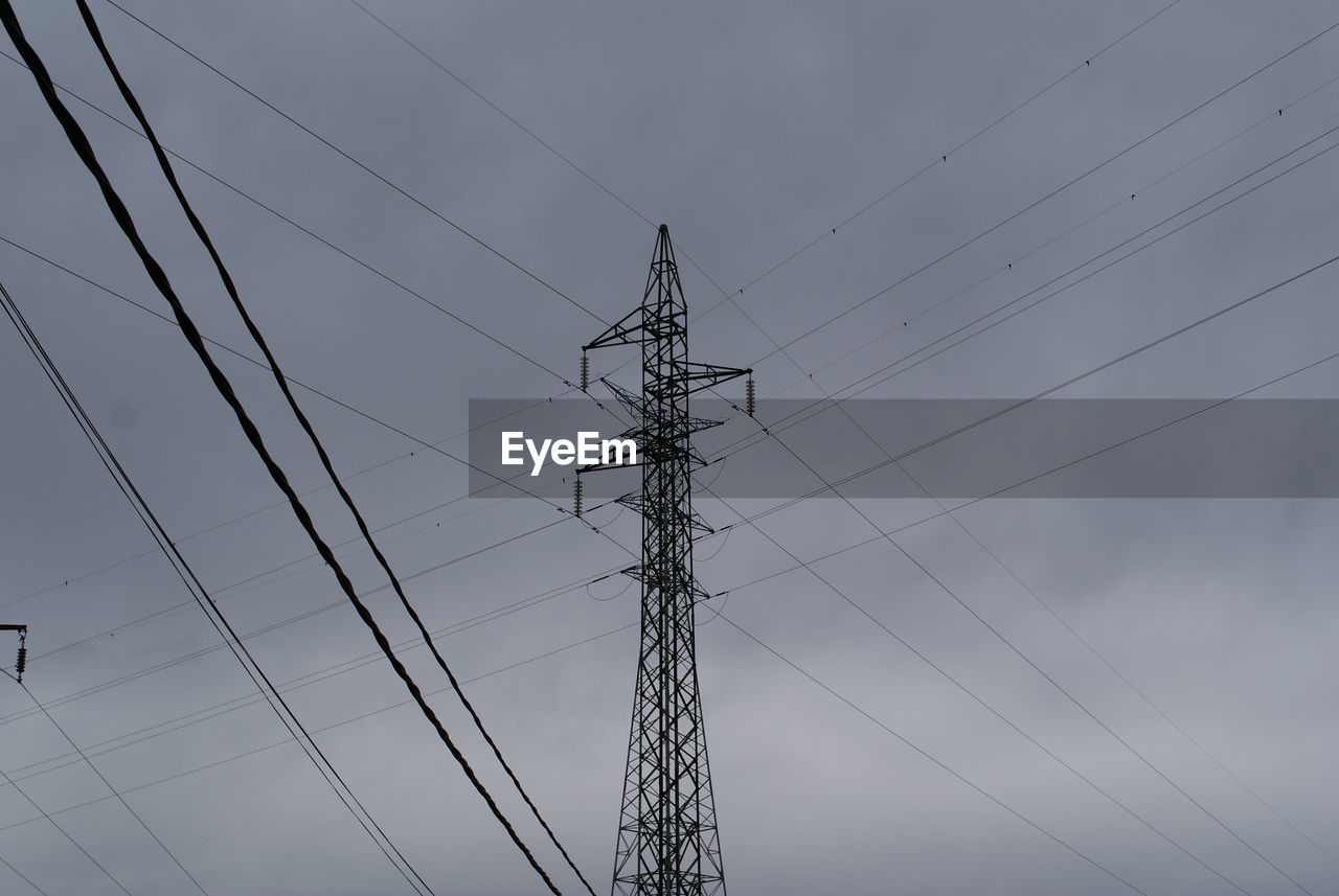 Low angle view of electricity pylon against sky