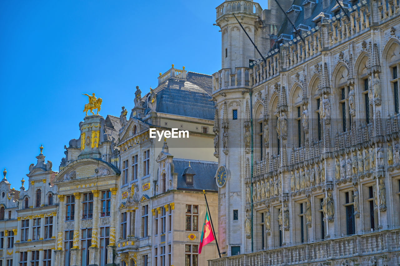 LOW ANGLE VIEW OF BUILDING AGAINST BLUE SKY