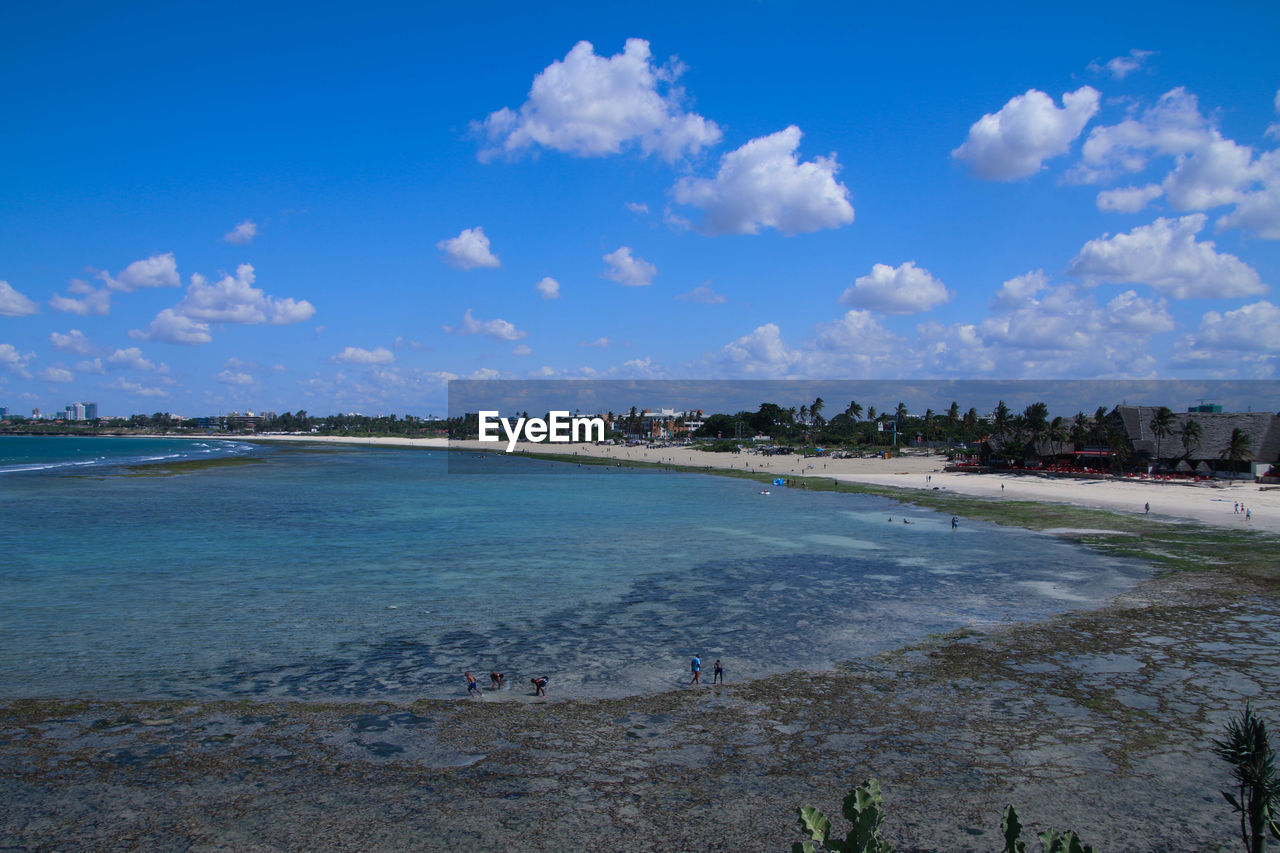 View of beach against cloudy sky