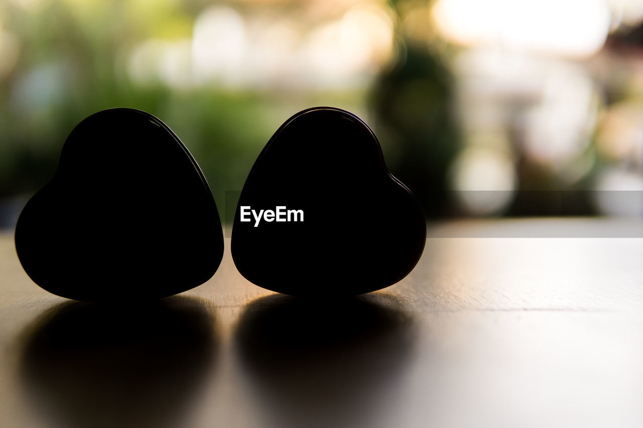Silhouette of heart shape on table
