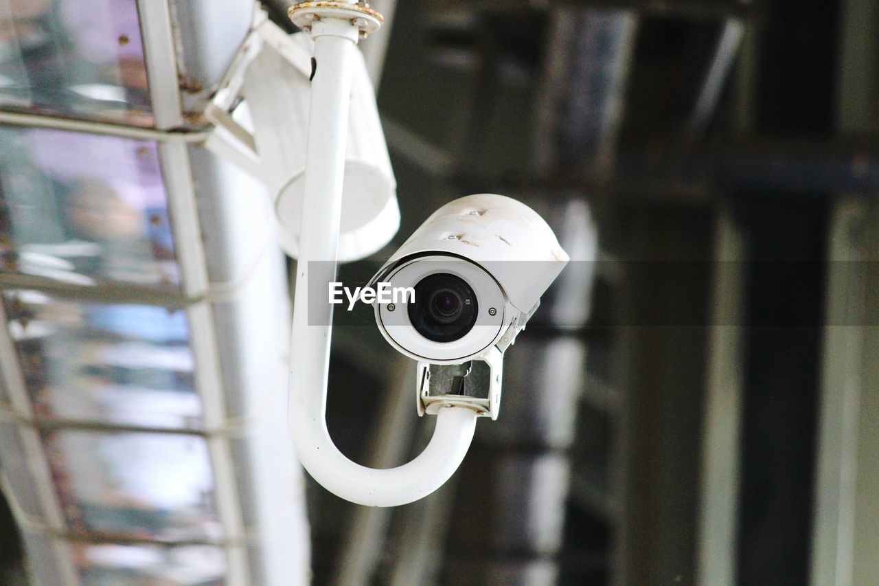 Low angle view of white surveillance camera