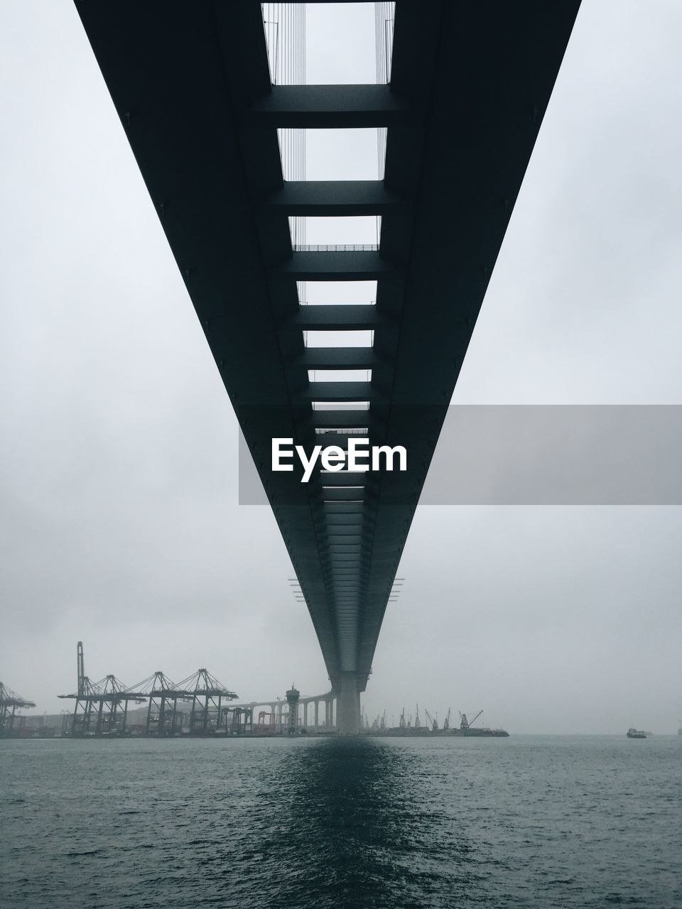 Low angle view of bridge over river against sky