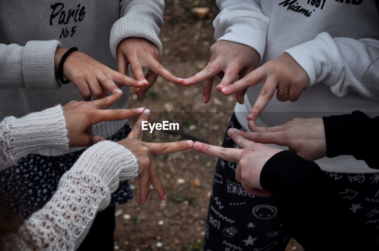 Cropped image of friends making star shape