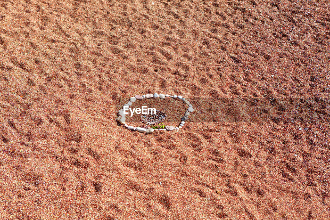 Red sand beach background . stones composition on the beach , vacation concept