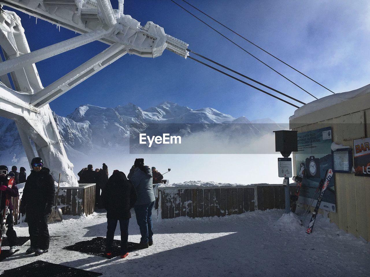 GROUP OF PEOPLE ON SNOW COVERED MOUNTAIN