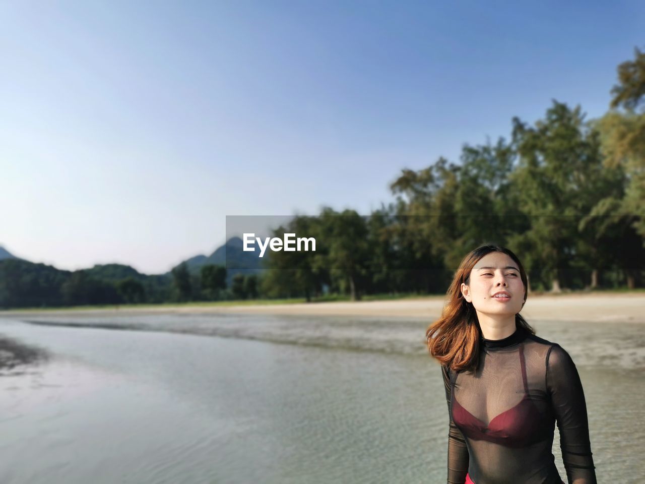 Young woman standing at beach