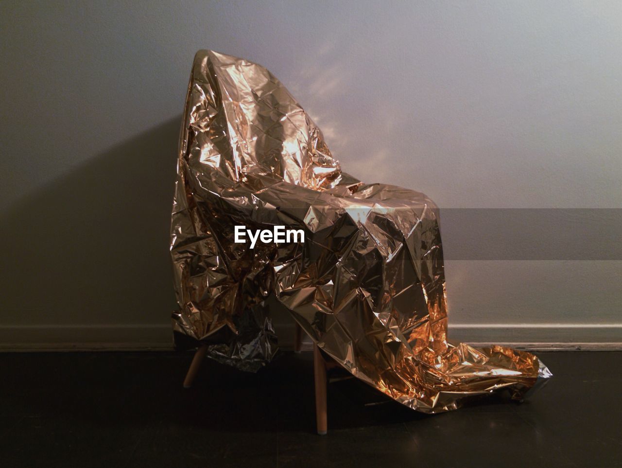 Chair wrapped in gold sheet