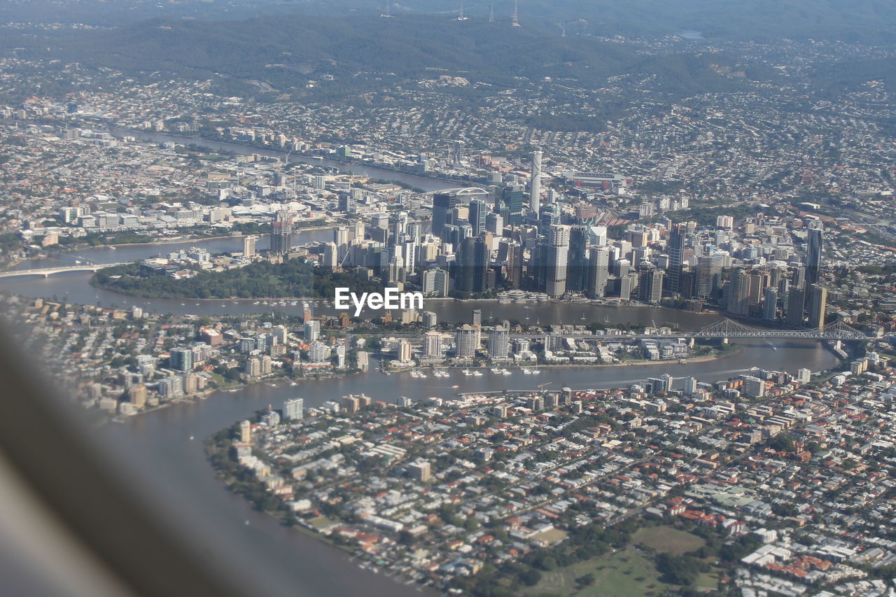 Aerial view of buildings seen through airplane window