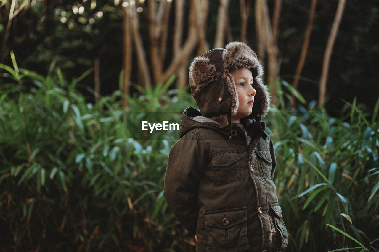 Man looking at camera in forest