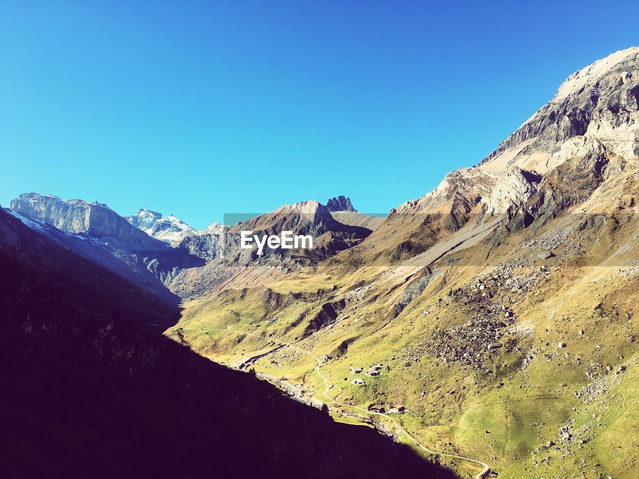 SCENIC VIEW OF MOUNTAINS AGAINST BLUE SKY