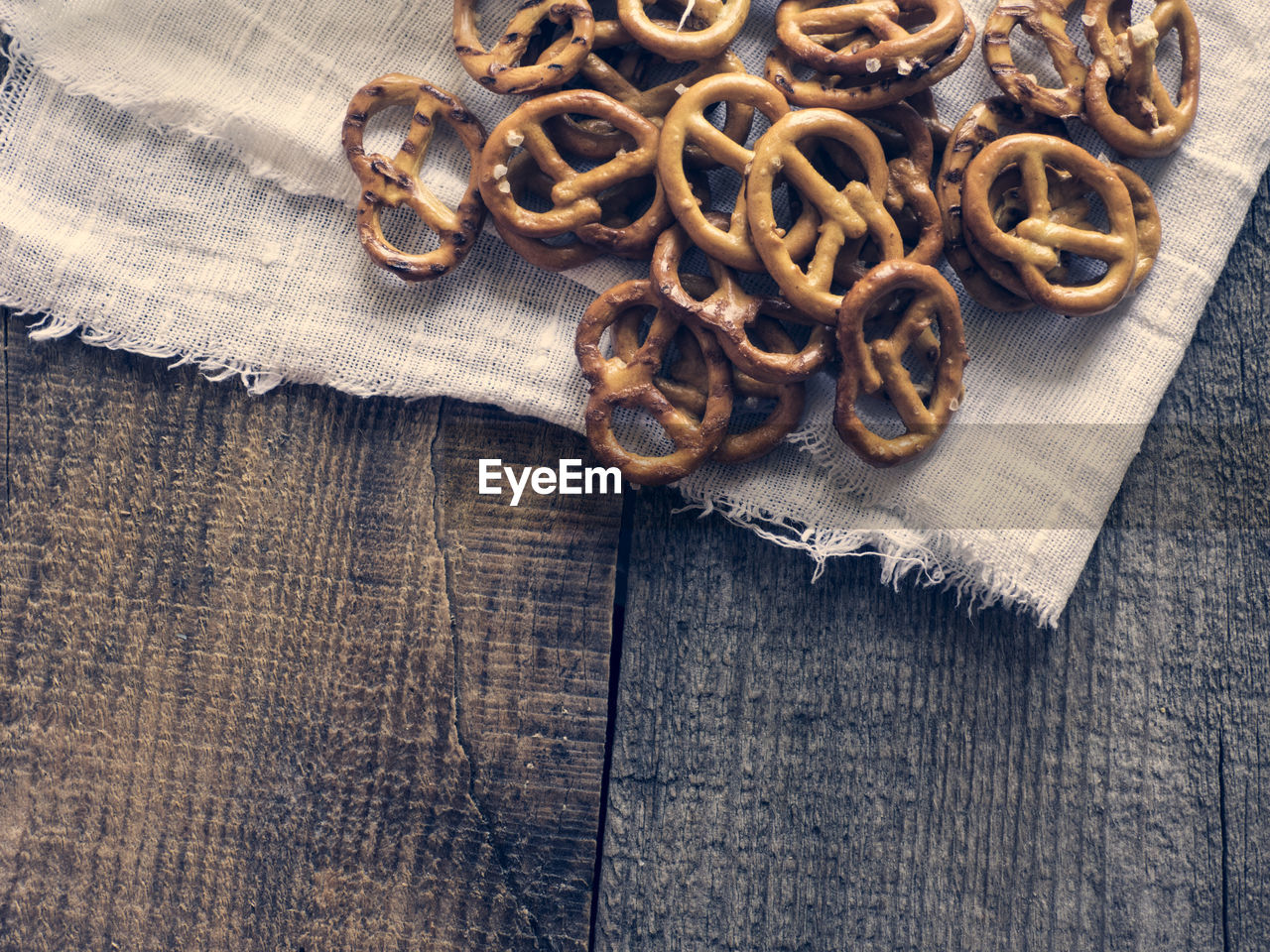 High angle view of wheat pretzels on linen fabric