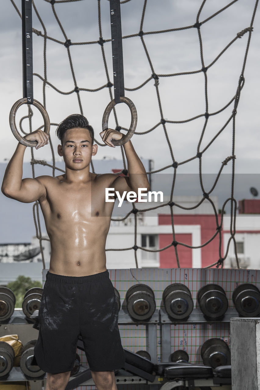 Man training at rooftop gym in bangkok