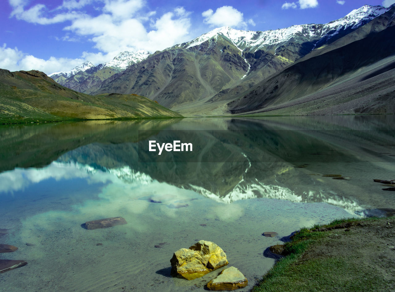 Scenic view of lake and mountains against sky