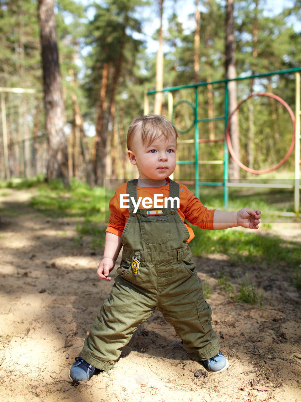 Cute boy looking away while standing in playground