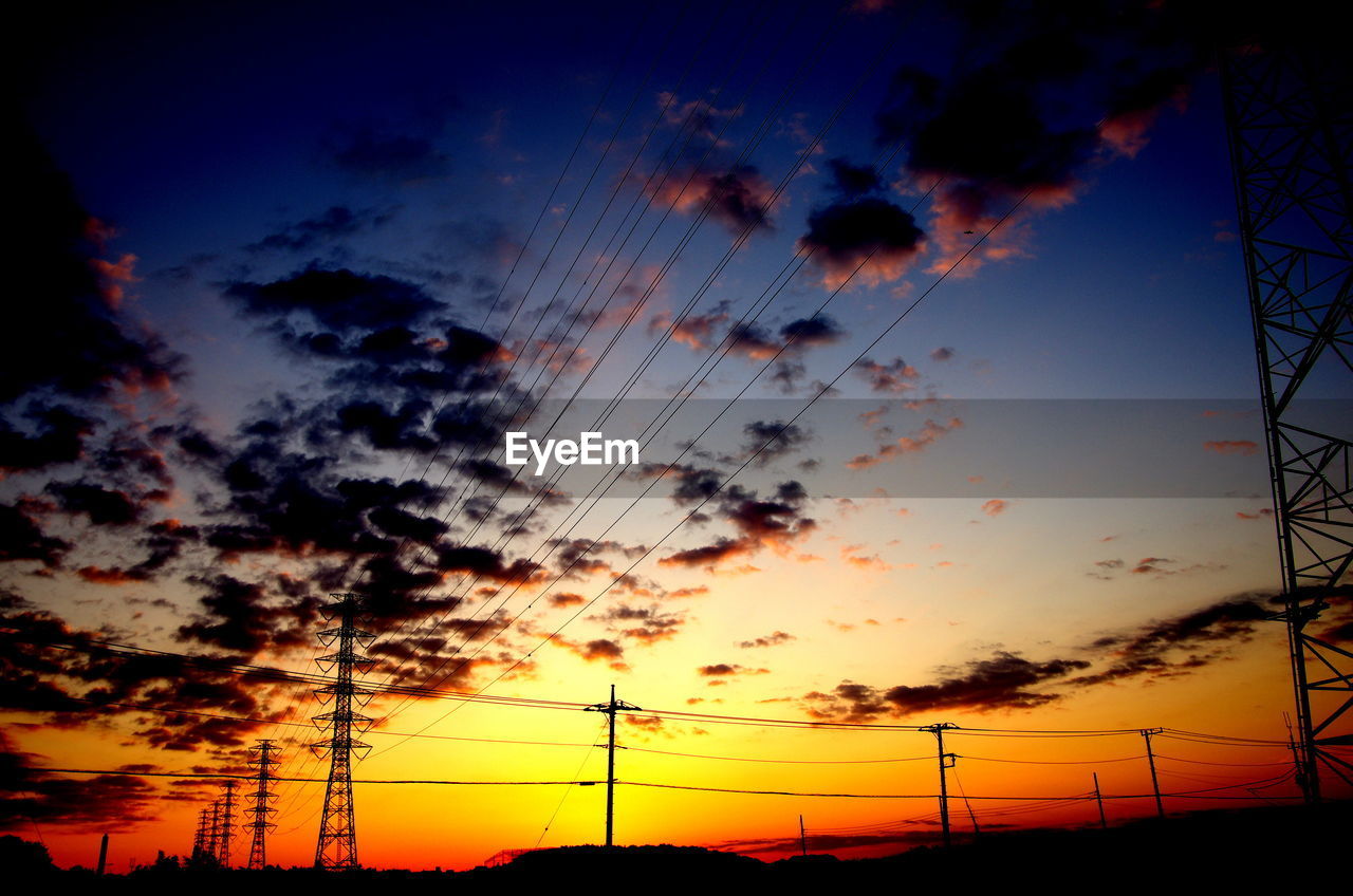 Low angle view of silhouette trees against sky at sunset