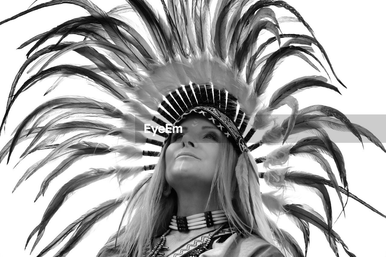 Low angle view of woman wearing headdress against clear sky