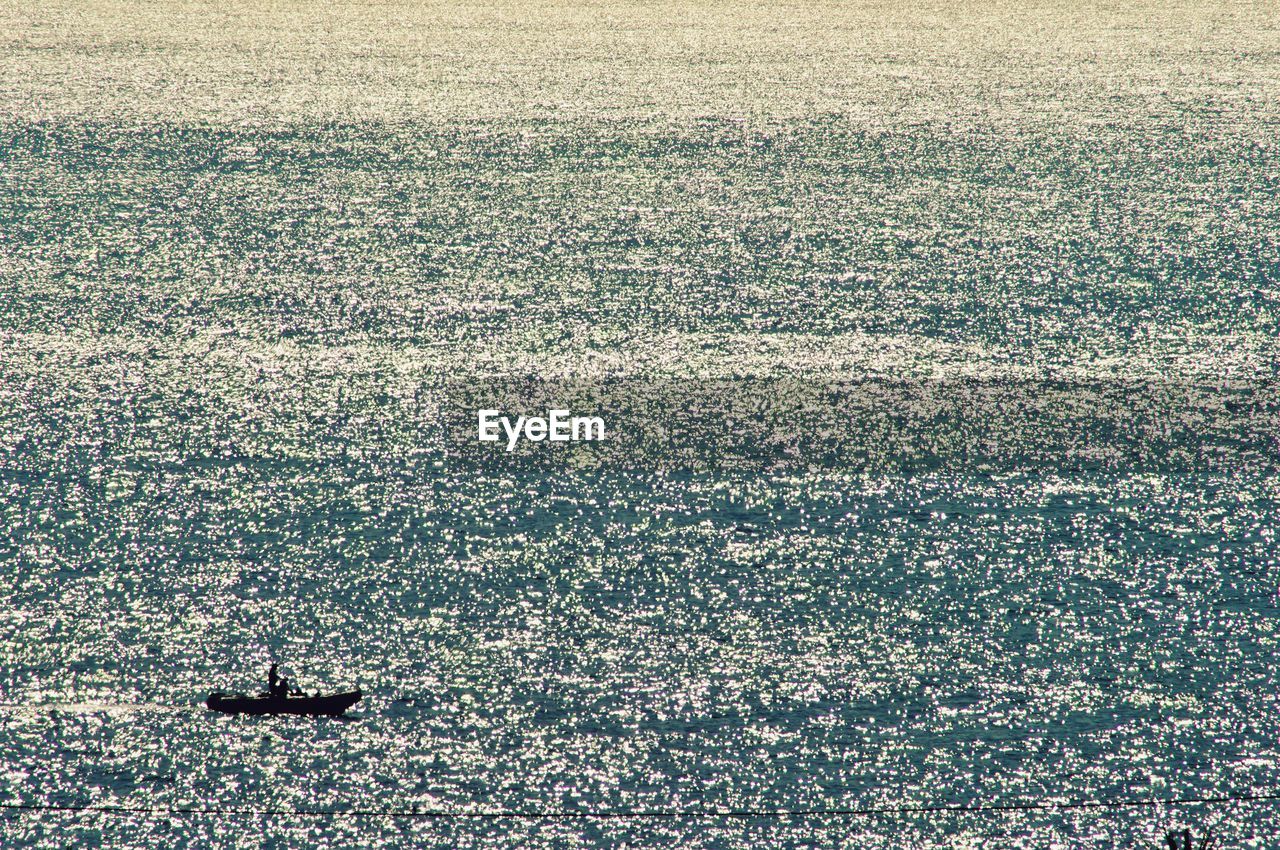 HIGH ANGLE VIEW OF SEA SEEN THROUGH BOAT