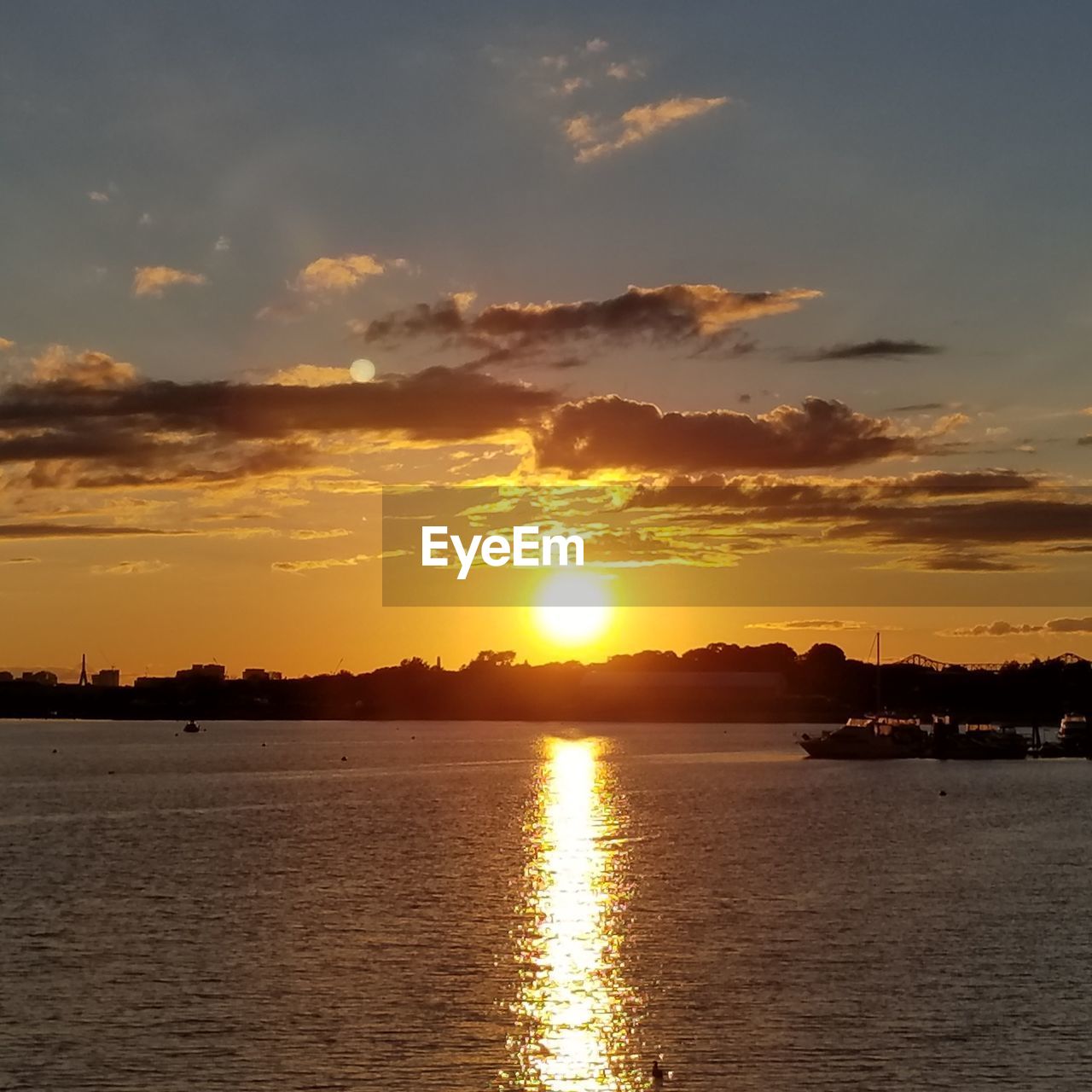 SCENIC VIEW OF SEA AGAINST ORANGE SKY DURING SUNSET