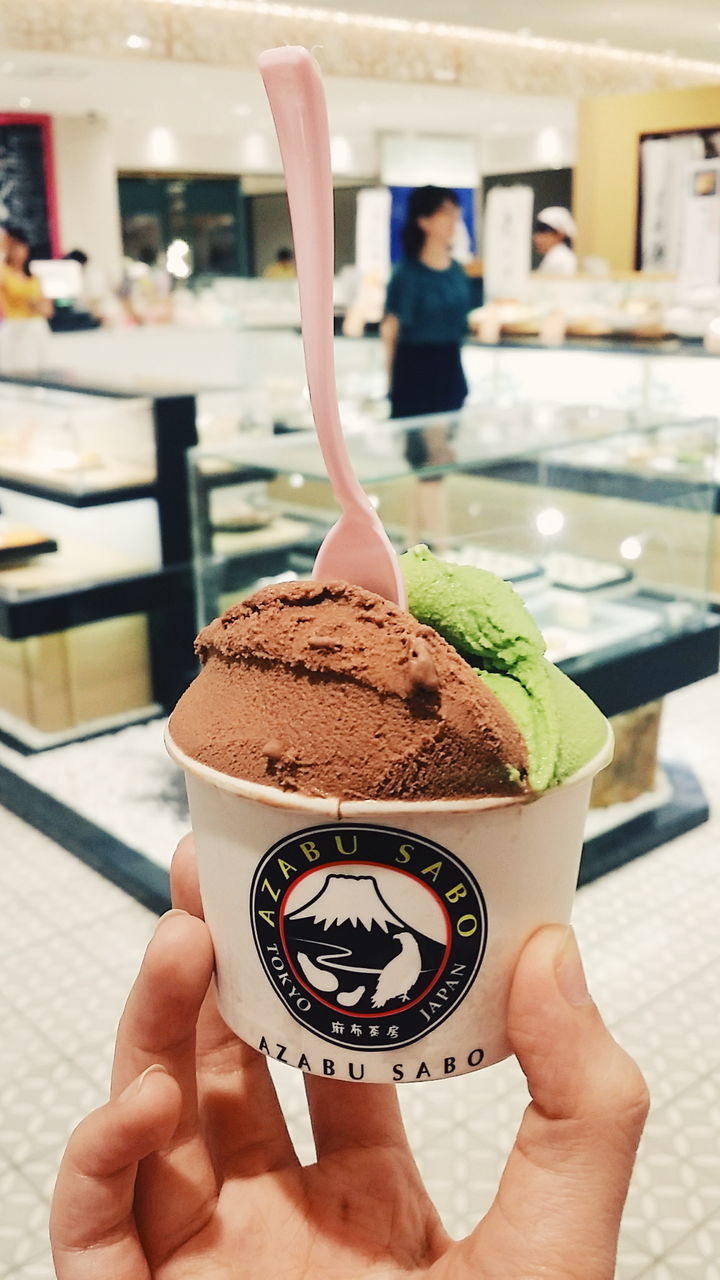 WOMAN HOLDING ICE CREAM IN RESTAURANT