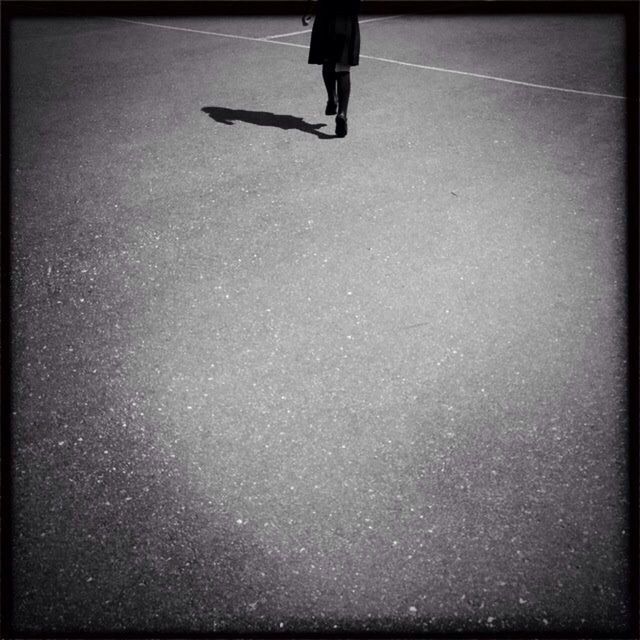 LOW SECTION OF WOMAN STANDING ON TILED FLOOR