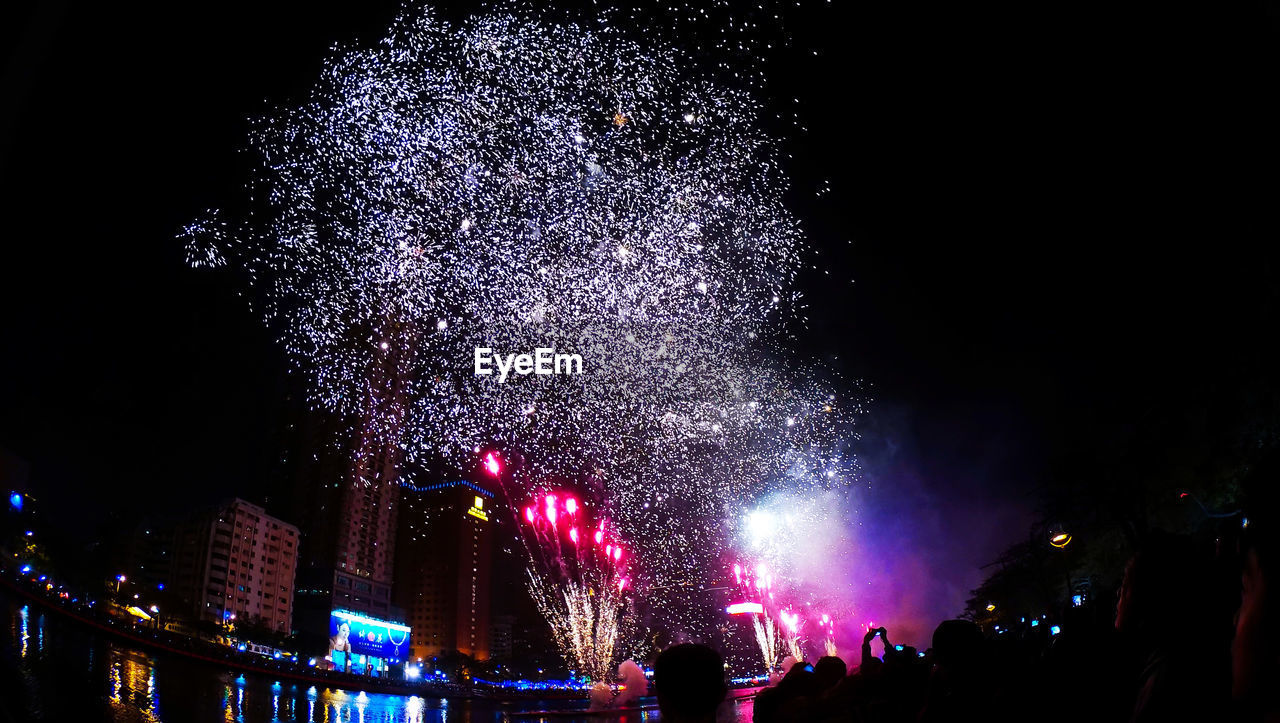 LOW ANGLE VIEW OF FIREWORKS DISPLAY