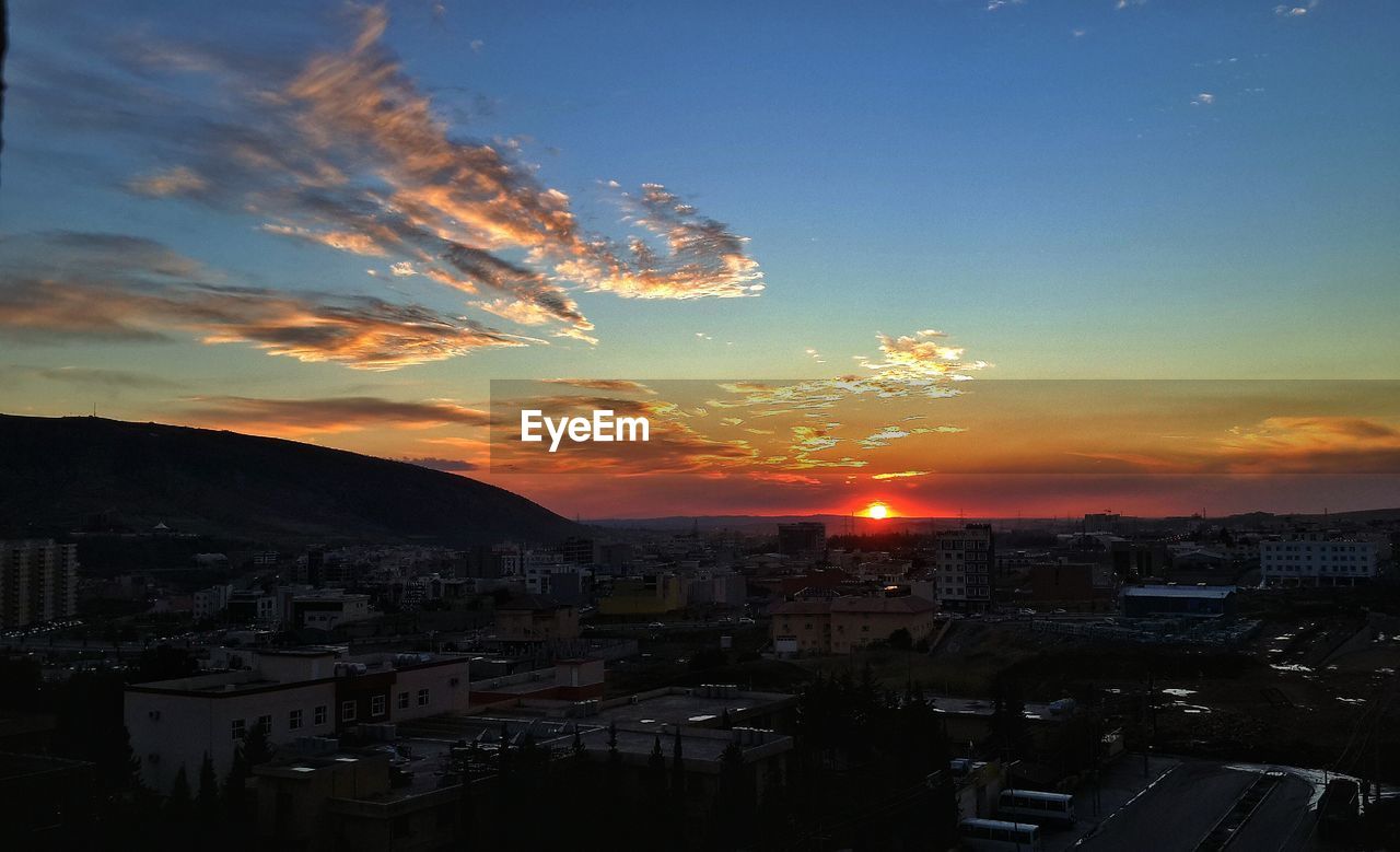 Cityscape against sky during sunset