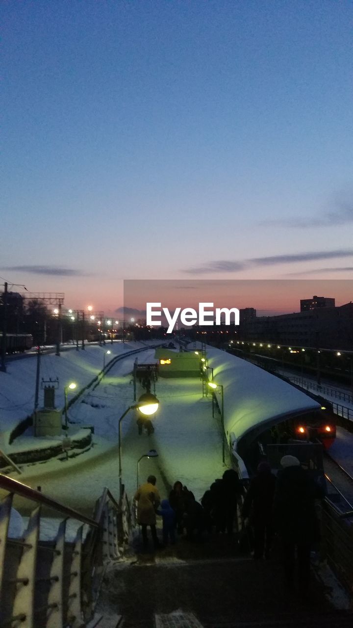 ILLUMINATED LIGHTS AGAINST CLEAR SKY AT NIGHT