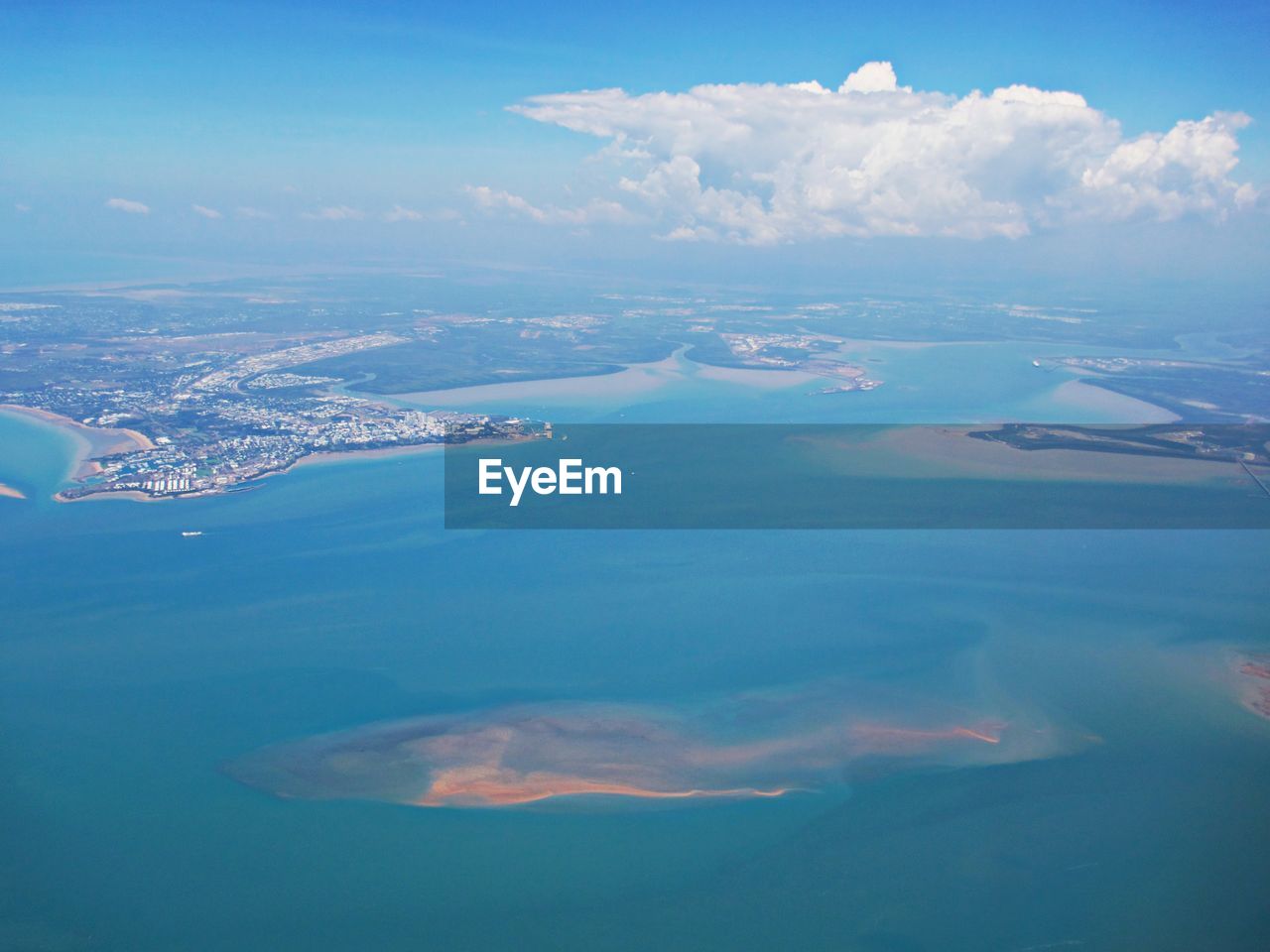 Aerial view of sea and city against sky