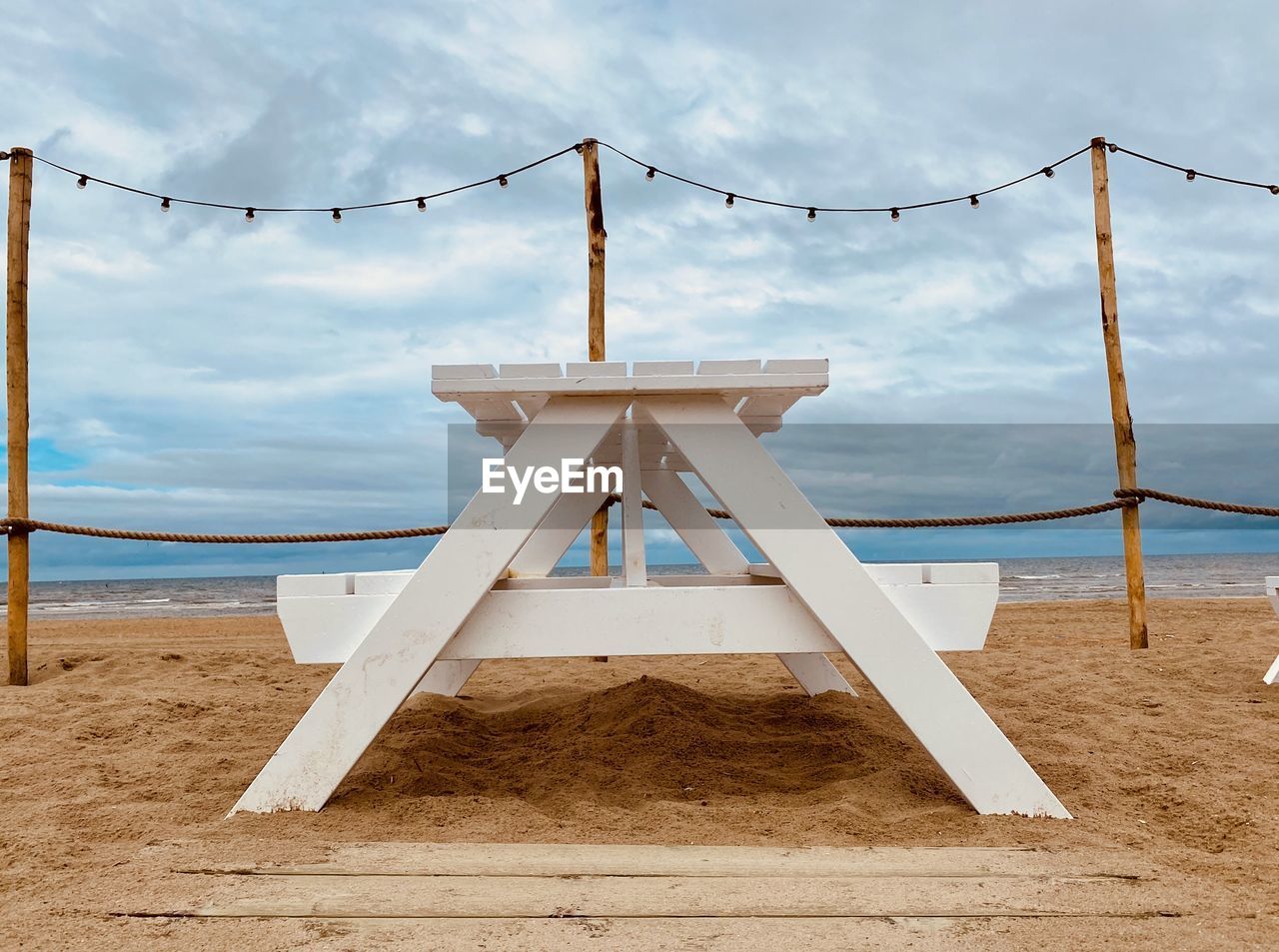 Beach against cloudy sky