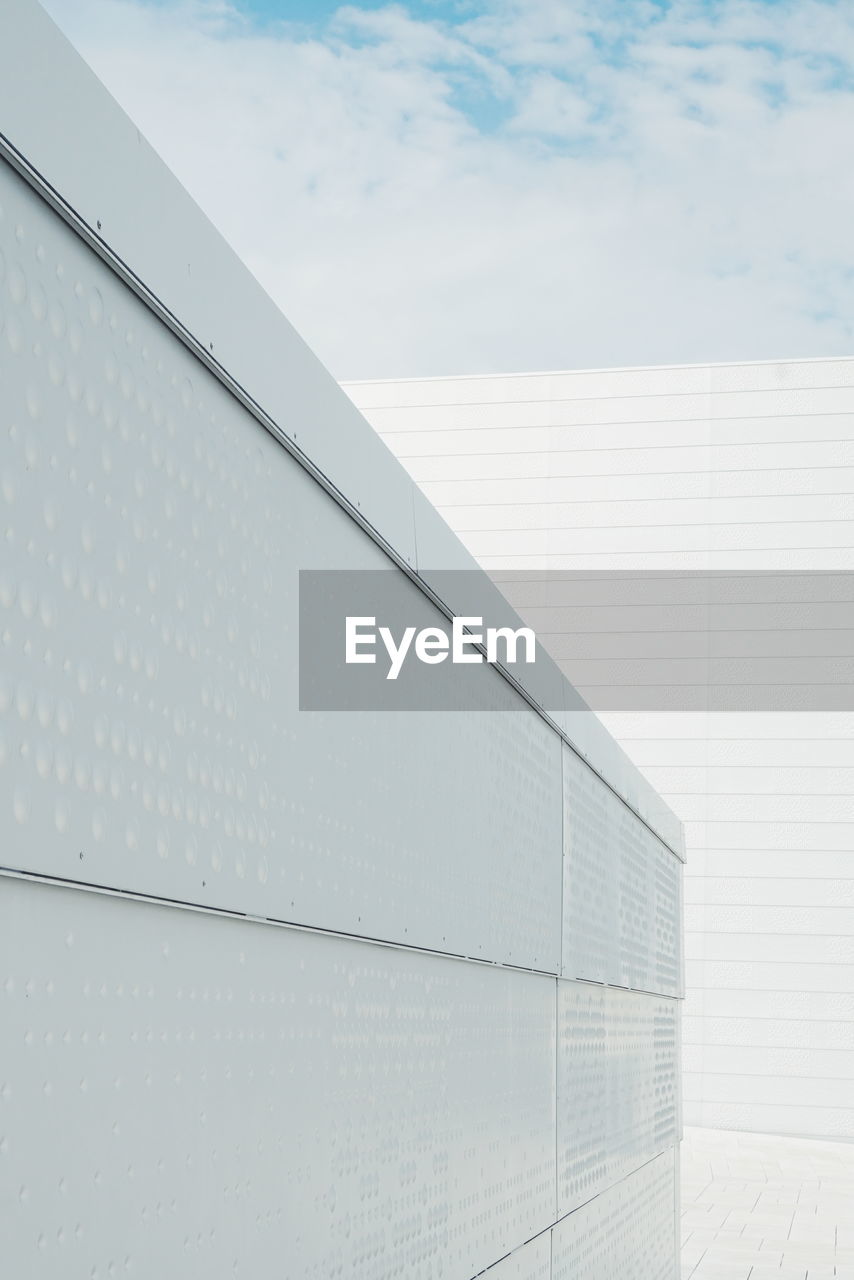 Low angle view of white oslo opera house against sky