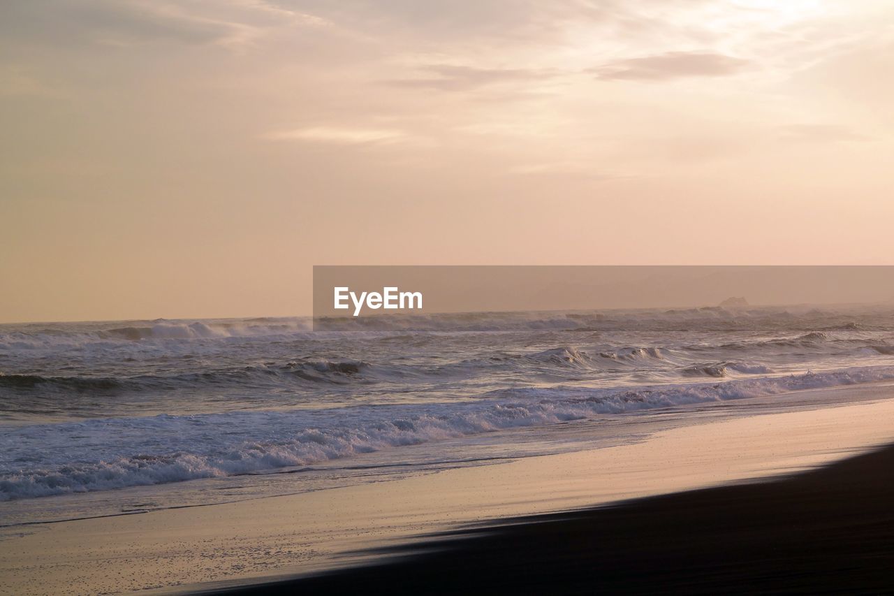 Scenic view of beach against sky during sunset