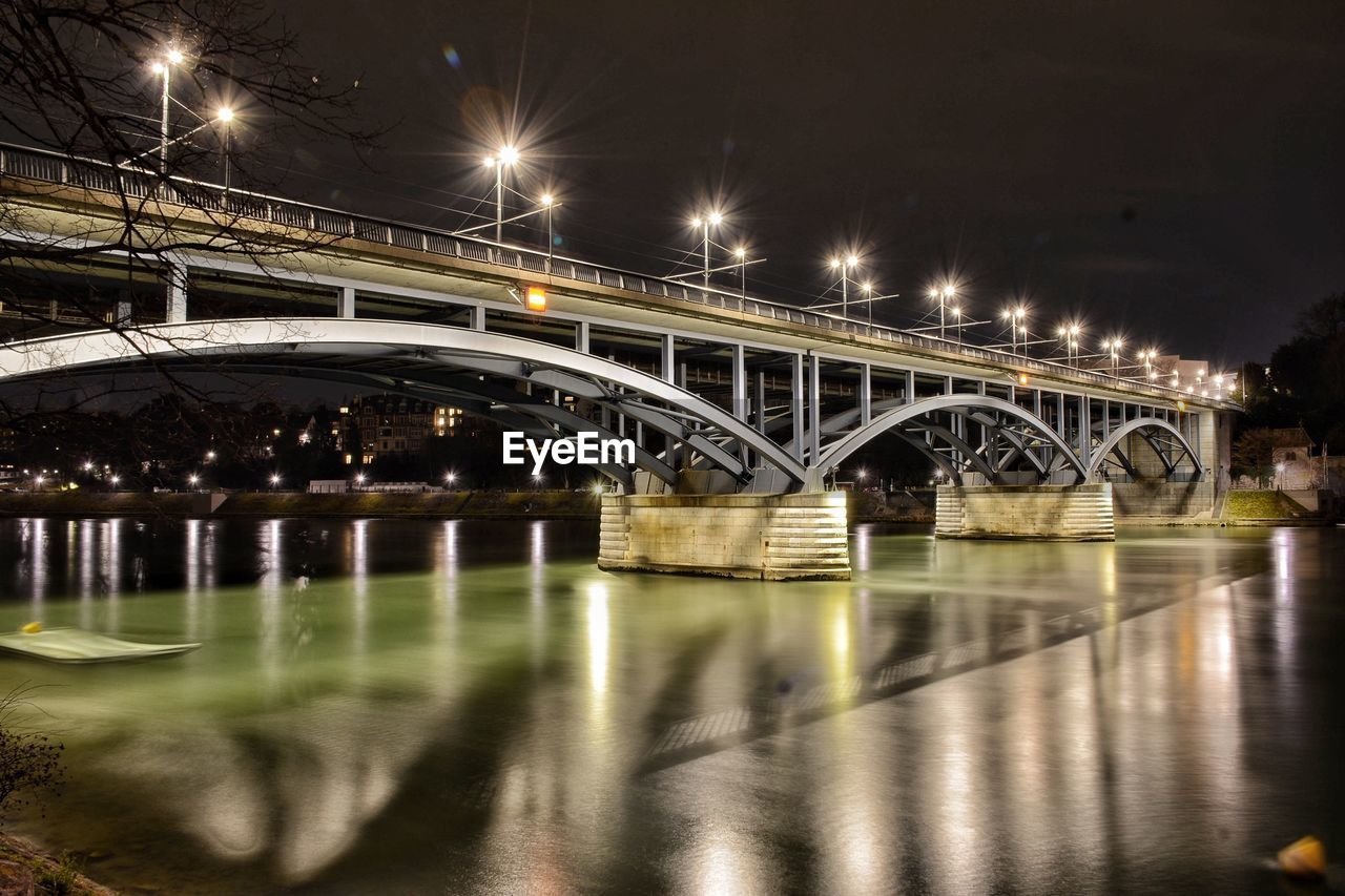 Illuminated wettsteinbrucke over river against sky