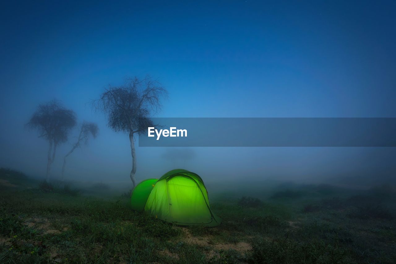 Tent on field against sky