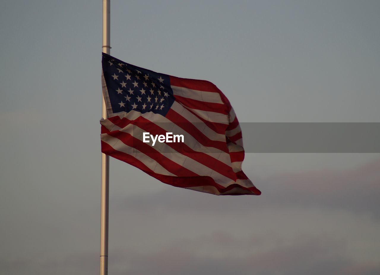 LOW ANGLE VIEW OF FLAG FLAGS AGAINST SKY