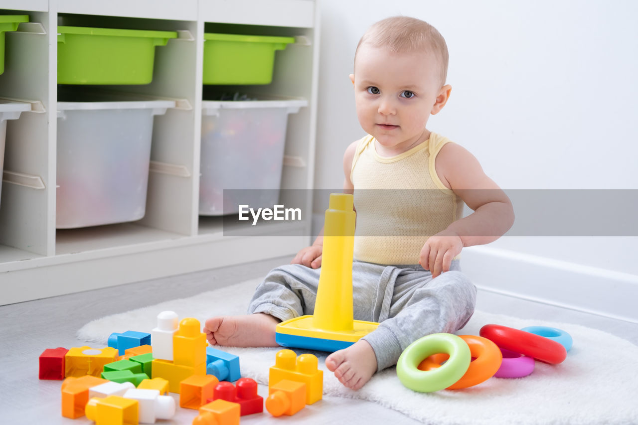 Cute baby playing with toys at home