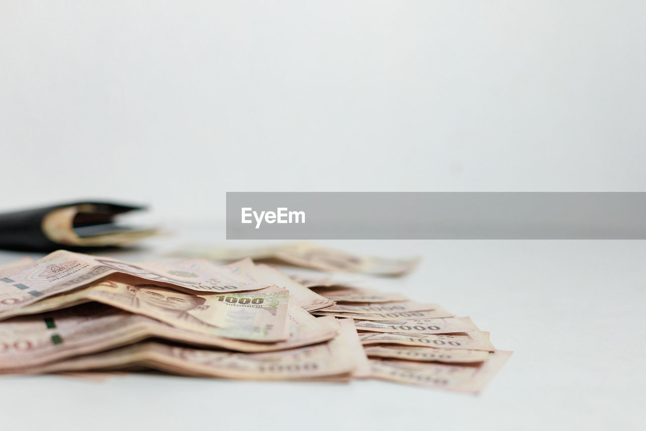 close-up of coins on table against white background