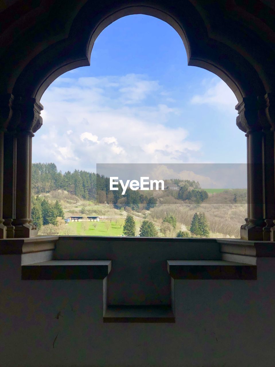 SCENIC VIEW OF MOUNTAINS SEEN THROUGH WINDOW