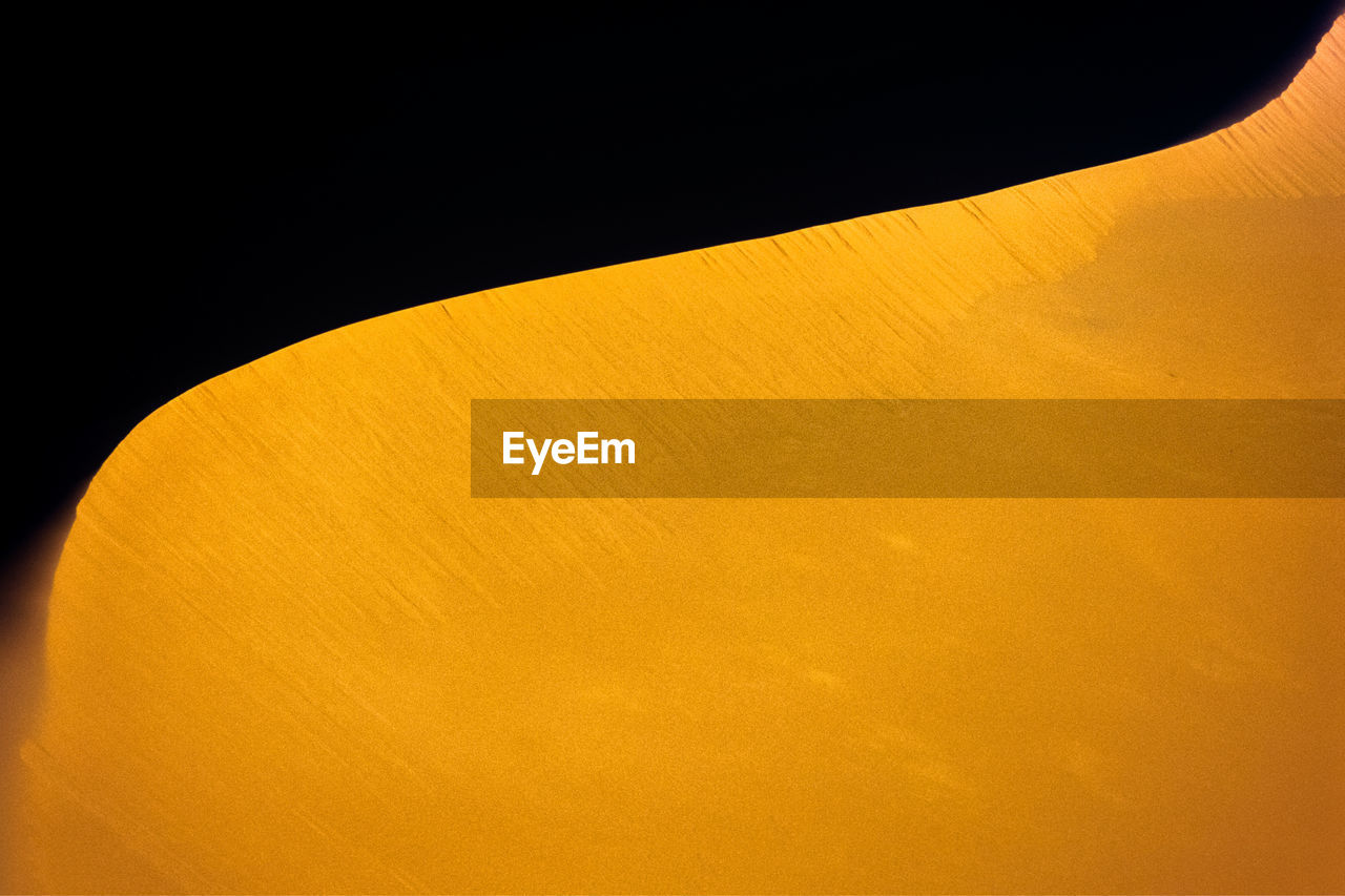 Idyllic shot of sand dune in desert during sunset